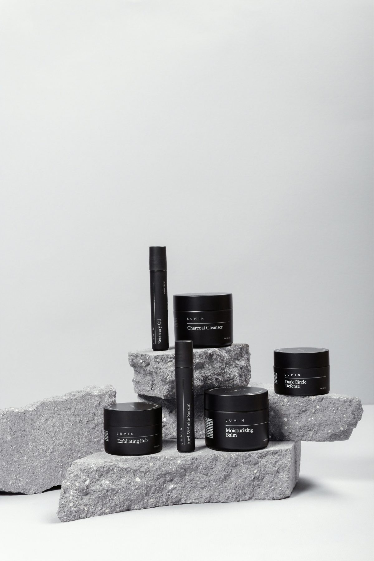 Dark cosmetic jars and bottles on stone blocks